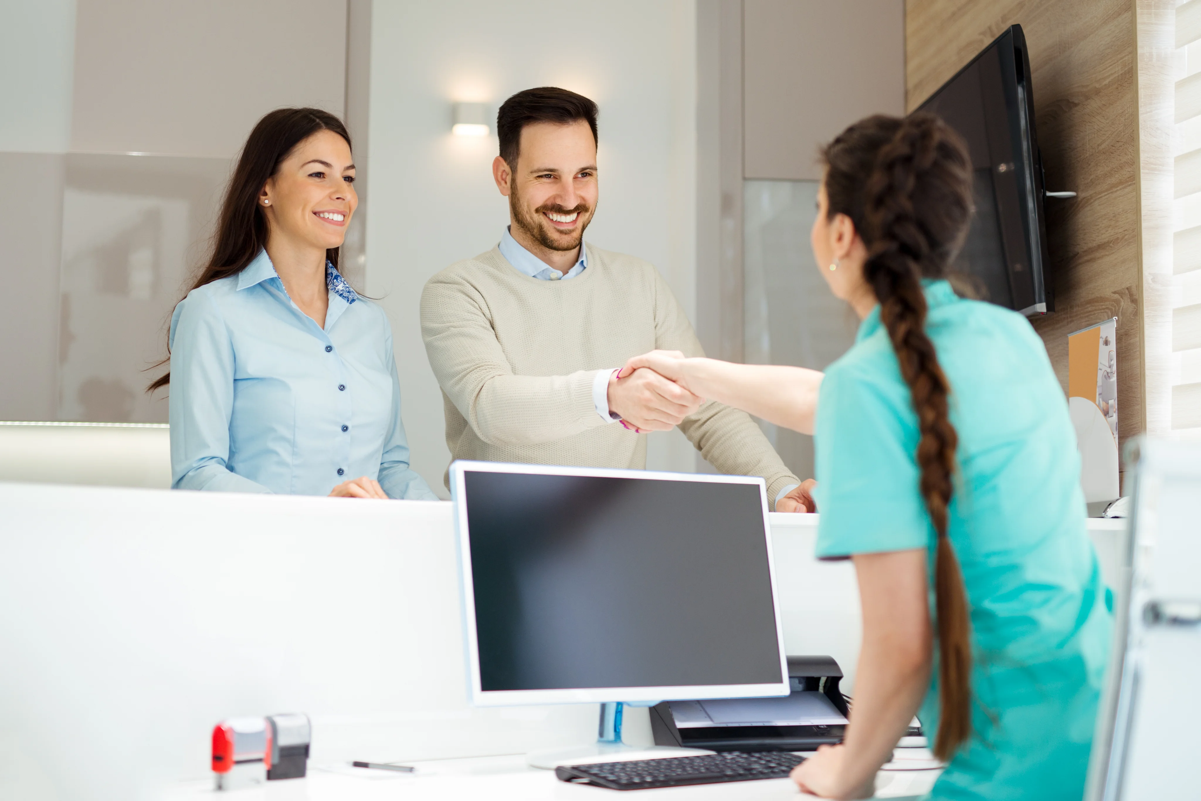 Dental team welcoming patient at Significance Dental Specialists