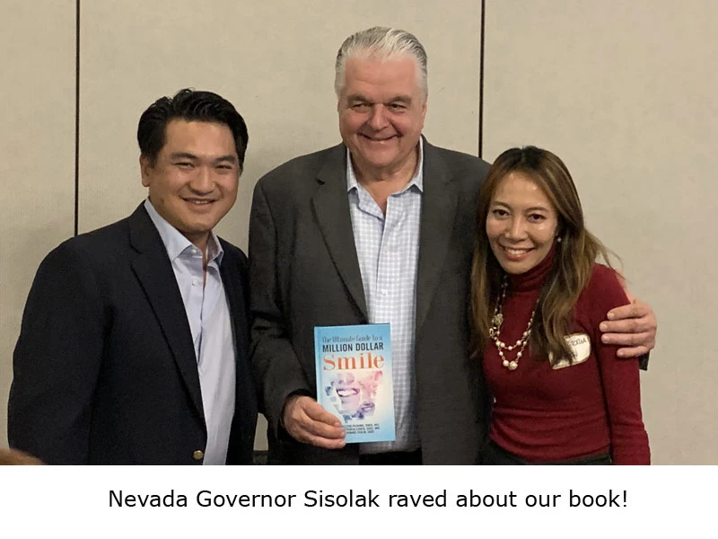 Dr. Huang with Million Dollar Smile book